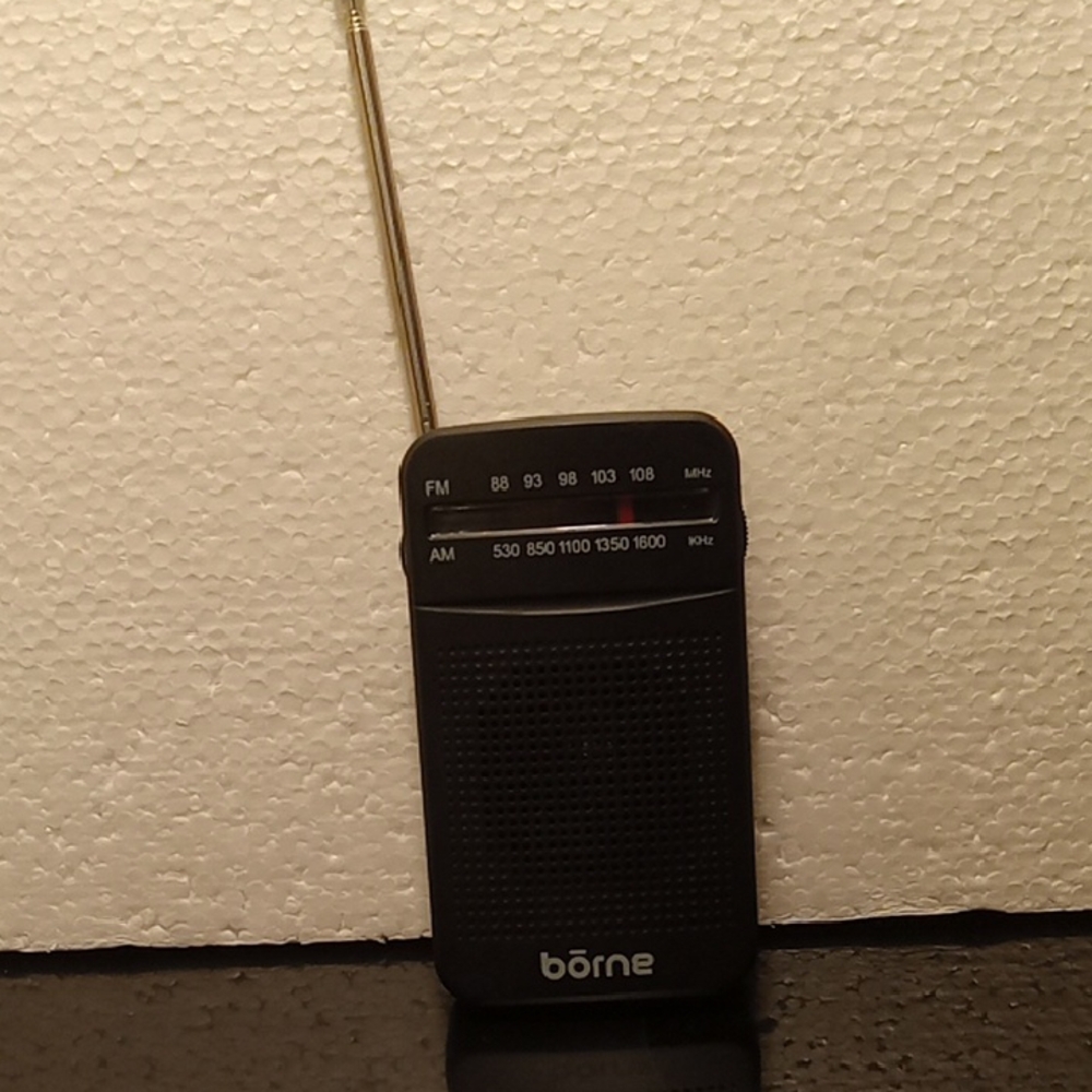 4  1/2 inch radio. Black new with no tags. No earphones.